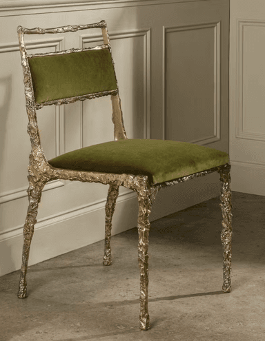 An armless side chair featuring a highly textured, organic silver cast metal frame and olive green velvet upholstery on the seat and backrest. — 3D model