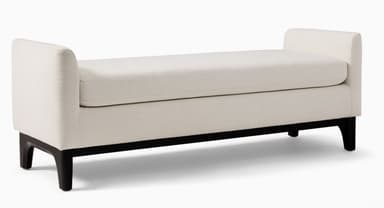 An off-white upholstered bench featuring integrated, low-profile armrests and supported by dark, tapered wooden legs. It has a single, removable seat cushion. — 3D model