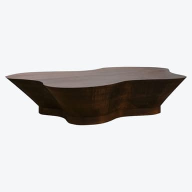 A low, wide coffee table made of dark wood, featuring a smooth top surface and highly textured, hand-carved sides and base. The shape is organic and irregular, resembling a natural formation with a rugged, chiseled aesthetic. — 3D model