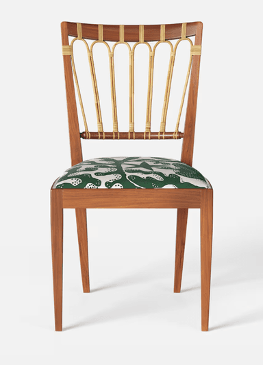 A wooden chair with a curved backrest featuring vertical, cane-wrapped spindles and a padded seat upholstered in a green fabric with a white abstract pattern. The chair has a solid wooden frame with four tapered legs. — 3D model