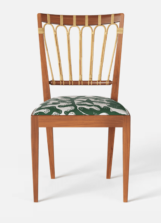 A wooden chair with a curved backrest featuring vertical, cane-wrapped spindles and a padded seat upholstered in a green fabric with a white abstract pattern. The chair has a solid wooden frame with four tapered legs. — 3D model