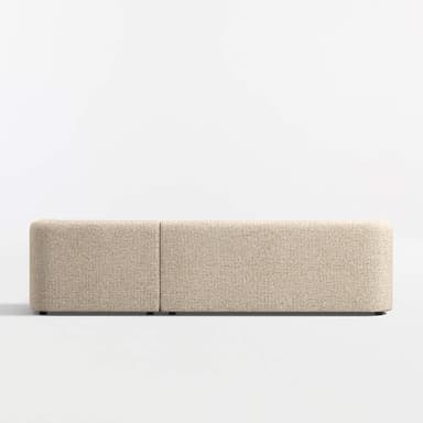 A sectional sofa with a chaise lounge attachment. The sofa features rounded armrests and a low profile design. It is upholstered in a textured fabric with a speckled pattern. The base is a dark, flat plinth or low legs. — 3D model