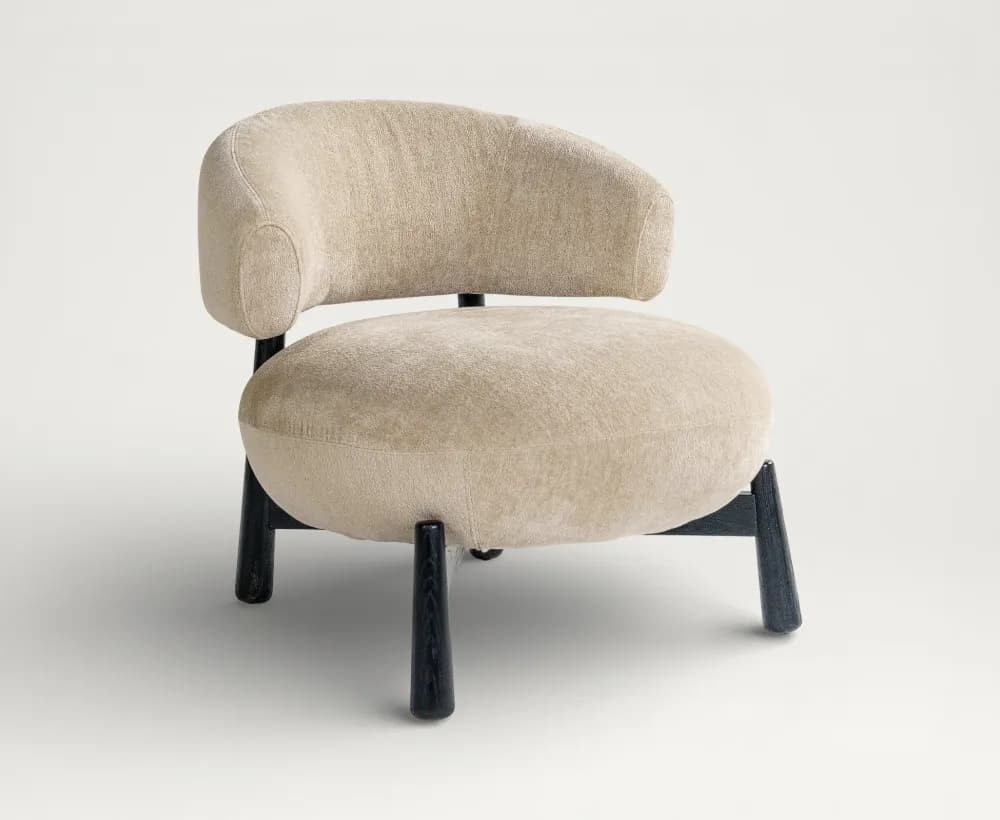 An upholstered barrel-shaped accent chair featuring a rounded back and seat, supported by four dark, tapered wooden legs. — 3D model