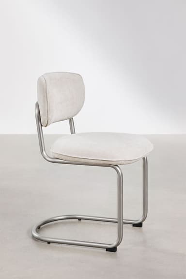 A modern armless chair featuring a bent tubular steel frame in a matte silver finish, with a padded, upholstered seat and a small, separate backrest covered in light-colored fabric. — 3D model