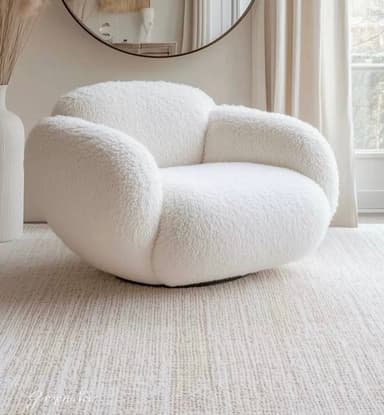 A modern, armless lounge chair featuring a soft, rounded, and organic silhouette, fully upholstered in a textured, off-white boucle fabric. The chair exhibits a plush, inviting form designed for comfort, with continuous, flowing lines that create a cloud-like aesthetic. It has a low profile suitable for contemporary living spaces. — 3D model