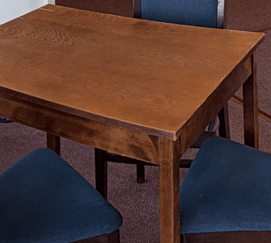 A simple, rectangular wooden table with a medium brown finish, featuring a flat tabletop and four straight, sturdy legs. — 3D model