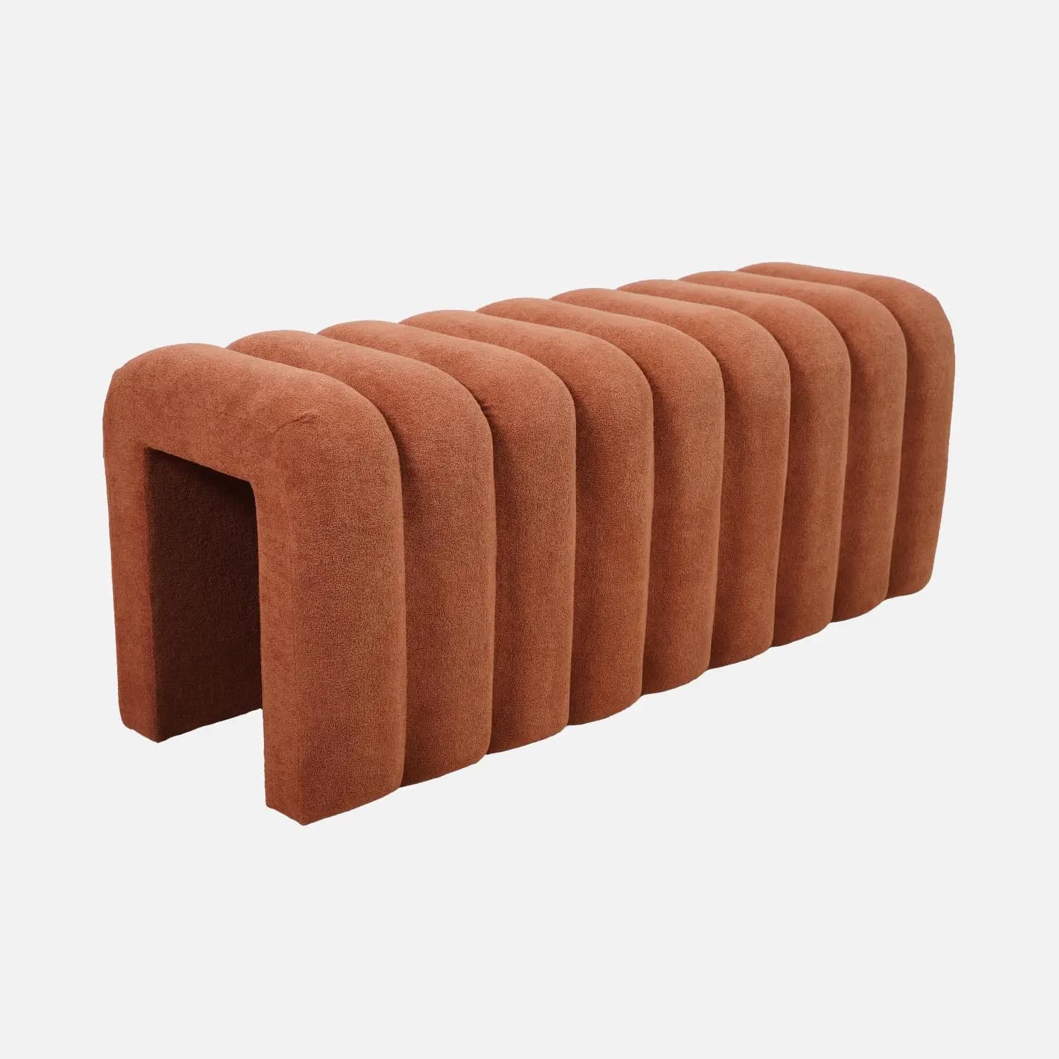 A contemporary bench with a distinctive fluted design. The bench features a series of rounded, vertical elements that create a rhythmic pattern along its length. It has an open U-shaped structure at one end, suggesting it can be used as a seating element or a decorative piece. The upholstery appears to be a textured fabric. — 3D model