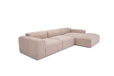 A sectional sofa with a chaise lounge extension. The sofa features a low profile, clean lines, and deep, plush seating. It is upholstered in a textured, neutral-toned fabric. The design appears modular or composed of distinct sections. — 3D model