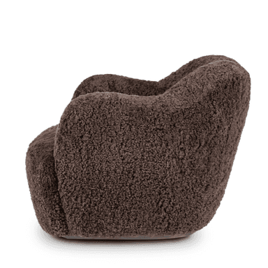 A dark brown armchair with a plush, textured upholstery resembling sheepskin or fleece. The chair features a rounded, organic silhouette with integrated armrests that flow seamlessly into the back and seat. The base is wide and solid, with no visible legs, giving it a grounded appearance. The overall design suggests a modern and comfortable aesthetic. — 3D model