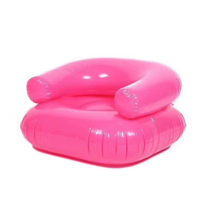 A vibrant hot pink inflatable lounge chair, designed for casual seating. It features a low-slung, circular base for the seat and a curved, U-shaped upper section that forms both the backrest and armrests. The chair is made from glossy, inflatable plastic material, likely PVC or vinyl, with visible seams from the heat-sealing process. — 3D model