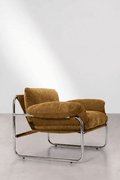 A modern lounge armchair featuring a polished tubular chrome frame and plush, warm brown upholstered cushions. The design evokes a Bauhaus aesthetic with its minimalist frame and deep, comfortable seating. — 3D model
