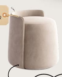 A contemporary, plush upholstered ottoman in a cylindrical form, featuring a low, integrated backrest. It is covered in a soft, beige velvet fabric and accented with a thin metallic gold piping along the edges of the backrest. — 3D model