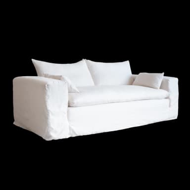 A white slipcovered sofa with two seat cushions and two back cushions. Two small accent pillows are placed on either end of the sofa. The sofa has a relaxed, casual style with a skirted base. — 3D model