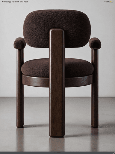 A contemporary dark wood armchair featuring a robust frame and plush, rounded upholstered components. The chair has a dark brown textured fabric on its seat, backrest, and rounded armrests. The sturdy wooden legs and back support are also dark-stained, creating a cohesive, modern aesthetic. — 3D model