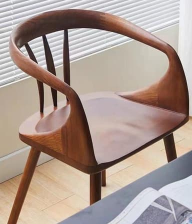 A wooden armchair with a curved backrest and armrests, supported by four tapered legs. The design features organic, flowing lines and a visible wood grain. — 3D model