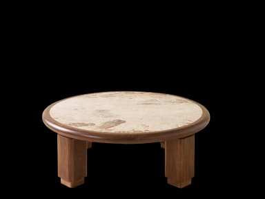 A low, round coffee table featuring a light-colored natural stone top, likely travertine, set within a thick, rounded frame of dark wood. The table is supported by four robust, chunky cylindrical wooden legs. — 3D model