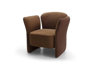 A contemporary upholstered armchair featuring a rounded backrest and integrated armrests that flow down to form the base. The chair is predominantly covered in a textured brown fabric, likely a tweed or boucle. The outer panels of the armrests, from the top down to the floor, are finished in a smoother, slightly darker brown material, possibly faux leather or a contrasting plain fabric, creating a subtle two-tone effect. The design emphasizes comfort with its soft curves and plush appearance, without visible legs. — 3D model