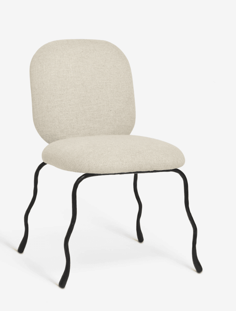 A modern chair with a cushioned seat and back, upholstered in a textured, light-colored fabric. The frame consists of four thin, black metal legs that are distinctly curved and irregular, giving the chair a whimsical and organic appearance. The backrest is rounded and slightly curved, complementing the shape of the seat. — 3D model