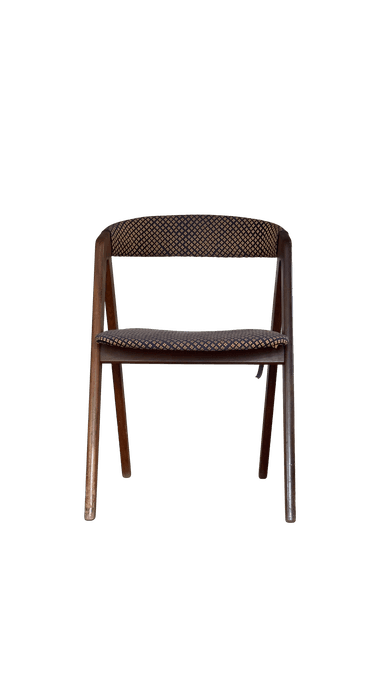 A wooden chair with upholstered seat and backrest. The upholstery features a repeating pattern of small, diamond-shaped motifs in a contrasting color. The frame appears to be made of wood with a dark finish. The chair has a simple, functional design. — 3D model