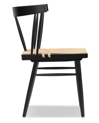 A modern dining chair featuring a matte black wooden frame and a natural woven rush seat. It has a spindle backrest with a curved top rail and tapered legs connected by stretchers. — 3D model