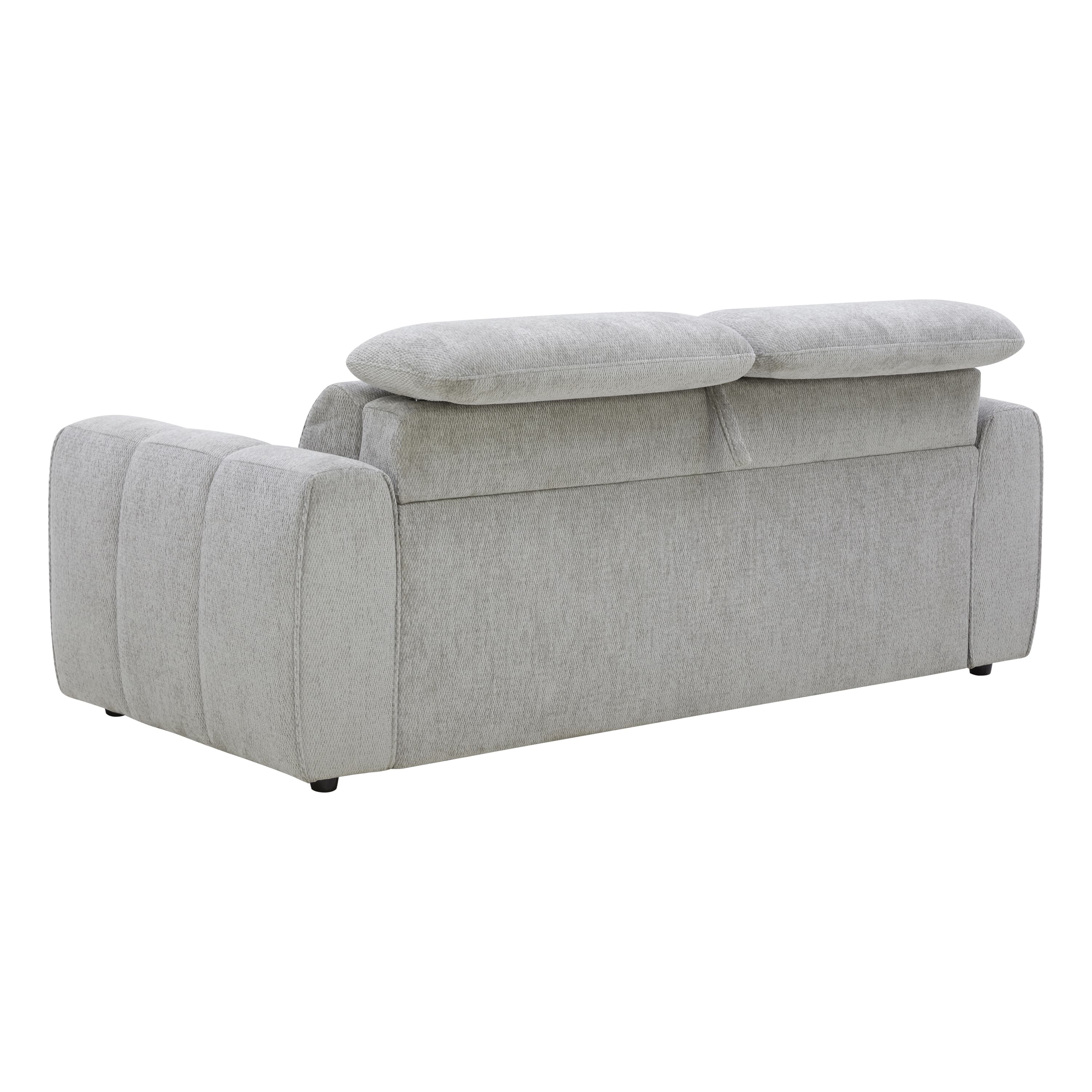 A contemporary sofa upholstered in a light gray fabric, featuring a sleek, minimalist design. The back cushions appear to have an integrated adjustable headrest mechanism, visible as a distinct, plush roll above the main backrest. The exterior sides of the armrests exhibit subtle vertical channel tufting, adding a touch of tailored detail. The sofa rests on low-profile, dark circular feet, suggesting a sturdy, modern construction. — 3D model