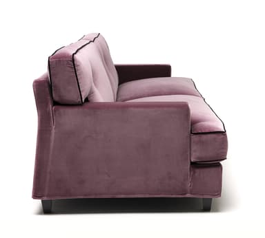A close-up view of a sofa section, showcasing plush velvet upholstery in a dusty rose color. The sofa features a tufted back cushion with a black button accent and decorative black piping along the edges of the headrest and armrest. The material appears soft and textured, indicative of velvet. — 3D model