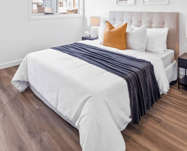 A modern upholstered platform bed featuring a channel-tufted headboard, presented with neutral-toned fabric. — 3D model