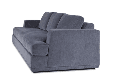 A contemporary upholstered sofa, viewed from the rear-right angle, featuring clean lines and a substantial form. It is covered in a textured slate gray fabric, presenting a modern aesthetic. The design includes thick, squared-off track arms and loose, plush back cushions. The sofa sits on a recessed plinth base, giving it a slightly floating appearance. The overall condition appears new and well-maintained. — 3D model