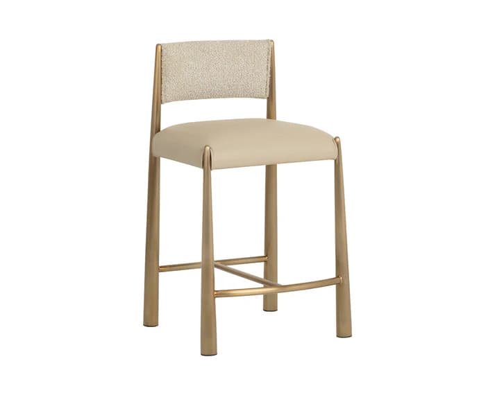 A contemporary bar stool with a metal frame and upholstered seat and backrest. The frame has a warm metallic finish and features tapered legs connected by a footrest. The seat and backrest are padded and covered in a neutral-toned fabric. — 3D model