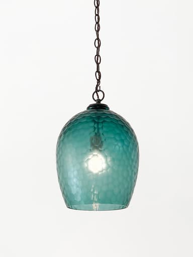 A single pendant light fixture featuring a globe-shaped shade crafted from hammered, translucent aqua-colored glass, suspended by a dark bronze or oil-rubbed bronze finish metal chain and canopy. — 3D model