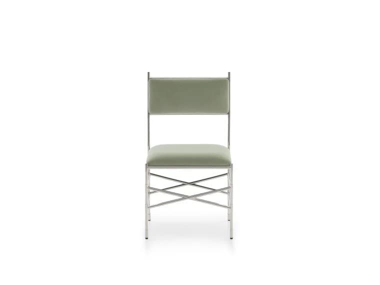An armless contemporary dining chair featuring a slender frame of polished chromed steel. It has a padded rectangular seat and a matching padded rectangular backrest, both upholstered in a muted sage green fabric. The chair's base is reinforced with a distinctive criss-cross stretcher design between the legs, contributing to its modern aesthetic and structural stability. The overall design is minimalist with clean lines. — 3D model