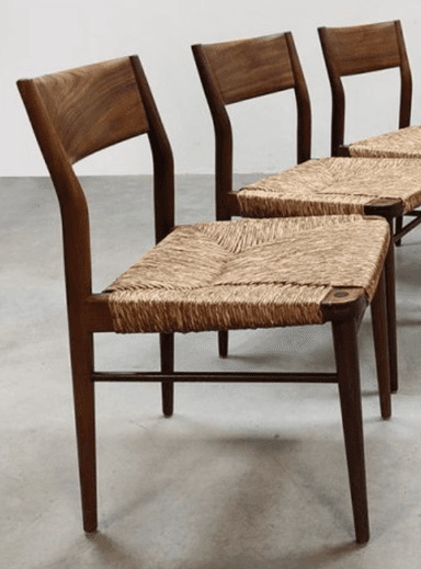 A wooden chair with a woven seat and backrest. The chair features tapered legs and a curved back. — 3D model