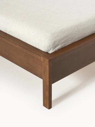A modern platform bed featuring a clean, minimalist design crafted from dark-stained wood. It includes a solid, rectangular panel headboard and a low-profile frame with integrated legs, designed to support a mattress without the need for a box spring. The bed frame exhibits a smooth, finished surface. — 3D model