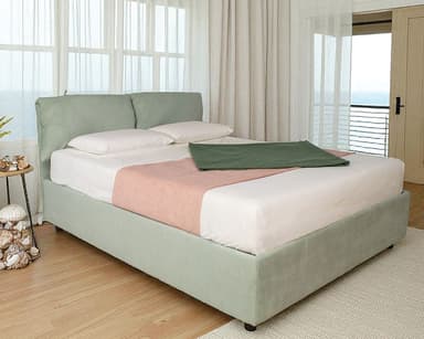 A contemporary upholstered platform bed featuring a light green fabric frame and a distinctive headboard composed of two soft, pillow-like cushions. — 3D model
