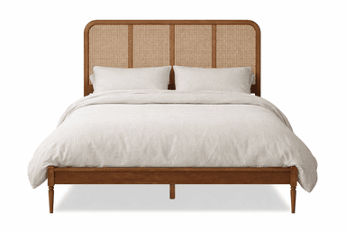A wooden bed frame with a headboard featuring a cane webbing insert and rounded top corners. The frame is supported by four tapered legs. The bed is dressed with white bedding, including a duvet and pillows. — 3D model