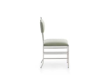 An armless contemporary dining chair featuring a slender frame of polished chromed steel. It has a padded rectangular seat and a matching padded rectangular backrest, both upholstered in a muted sage green fabric. The chair's base is reinforced with a distinctive criss-cross stretcher design between the legs, contributing to its modern aesthetic and structural stability. The overall design is minimalist with clean lines. — 3D model