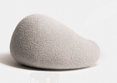 A light grey, upholstered, organically shaped piece of furniture, resembling a large smooth pebble or rock. Its surface appears to be a soft, textured fabric. — 3D model