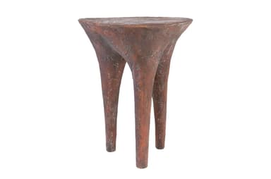 A small, three-legged end table with a textured, organic form. The tabletop is roughly circular and tapers downwards into three bulbous legs that spread outwards. The surface texture appears rough and pitted, suggesting a material like concrete, plaster, or a textured resin. — 3D model