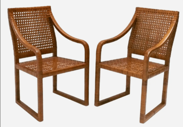 A contemporary armchair constructed from a light brown wooden frame and intricately woven cane panels. The chair features a high backrest, a rectangular seat, and smoothly curved armrests, all integrated into a cohesive design with a natural aesthetic. — 3D model
