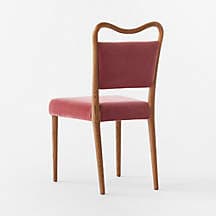 A contemporary dining chair with a curved wooden frame supporting upholstered seat and backrest. The chair has four tapered wooden legs. The upholstery appears to be a velvet fabric in a muted red or burgundy hue. — 3D model