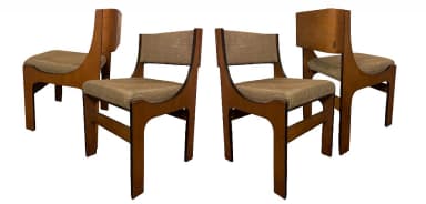 A wooden chair with a upholstered seat and back. The frame is constructed from dark wood with a smooth finish. The seat and back are covered in a textured, light brown fabric. — 3D model