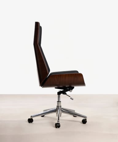 An armless office chair with a molded plywood shell finished in a dark wood veneer, supported by a polished aluminum five-star swivel base with casters. The chair features a high back and a subtly curved seat. — 3D model