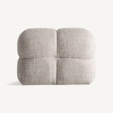 A low, upholstered ottoman with rounded edges, divided into four cushioned sections by stitched seams. The upholstery has a textured appearance with a mix of light and dark fibers, giving it a speckled effect. A small white tag with 'VICAI' is visible on the lower left side. — 3D model