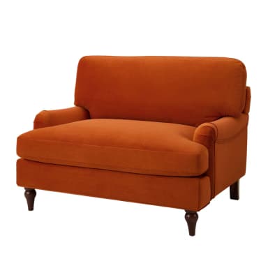 A plush, deep-seated armchair upholstered in a vibrant rust orange velvet fabric. It features rolled arms, a T-cushion backrest, and a single seat cushion. The chair is supported by four dark, turned wooden legs. — 3D model