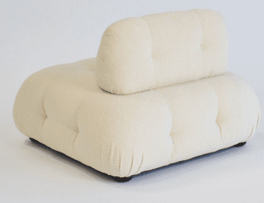 An off-white, deeply tufted, armless modular lounge chair upholstered in a boucle fabric. It features a low-profile design with a separate, equally tufted backrest cushion that appears to rest against the main base. The overall form is soft and rounded, indicative of comfort-focused design. — 3D model