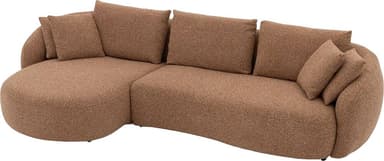 A modern, curved sectional sofa upholstered in a textured, light brown or tan boucle-style fabric. The sofa features a low-profile design with an integrated chaise lounge section on one side, offering ample seating and lounging space. Its backrest and armrests are gently rounded, providing a soft, organic aesthetic. Several loose back cushions are provided for comfort. — 3D model