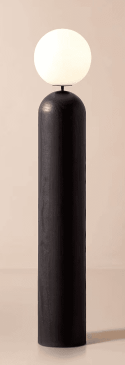 A minimalist modern floor lamp featuring a tall, cylindrical base made of dark stained wood, topped with a spherical, opaque white glass diffuser. The design is sleek and contemporary, emphasizing clean lines and a simple geometric form. The wood grain is subtly visible through the dark finish, adding texture to the otherwise smooth surface. The light emitted from the spherical shade appears soft and diffused. — 3D model
