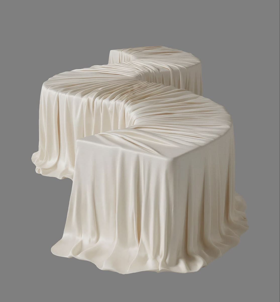 A long, serpentine-shaped bench entirely covered in a light, cream-colored fabric with an intricate pleated surface. — 3D model
