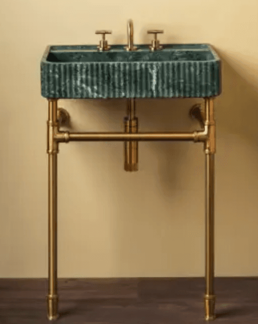 A contemporary console sink featuring a rectangular basin crafted from fluted green marble, supported by an exposed brass pipe stand with integrated widespread faucet and cross-handle controls. — 3D model