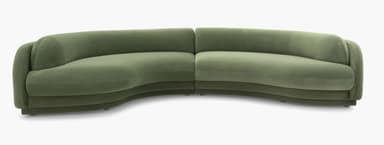 A modular, curved sectional sofa upholstered in a soft, green velvet-like fabric. The sofa features rounded edges and a layered, almost sculptural base. The design is contemporary with organic, flowing lines, suggesting a modern or art deco-inspired aesthetic. It appears to be composed of at least two connected sections to form the corner shape. — 3D model